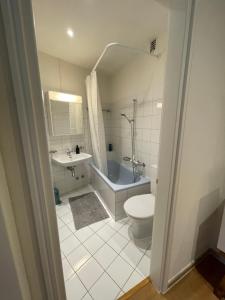 a bathroom with a toilet and a tub and a sink at Appartamento La Torretta in Locarno +32 photos