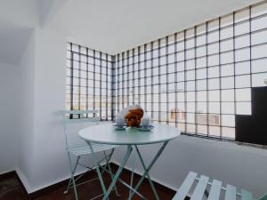 a table in a room with a tiled wall at La Casa del Conde - Un alojamiento único en Écija in Écija