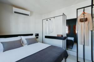 a bedroom with a bed and a dress on a rack at La Casa del Conde - Un alojamiento único en Écija in Écija