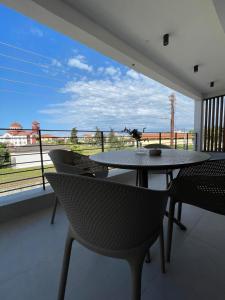 a table and chairs on a balcony with a view at Αura Luxury Apartments in Ierissos