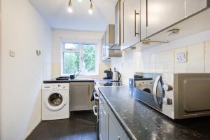 a kitchen with a washer and dryer in it at Central two bedroom apartment-Gillingham in Gillingham +10 photos