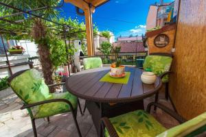 a wooden table and chairs on a patio at Ferienhaus für 4 Personen ca 62 qm in Crikvenica, Kvarner Bucht Crikvenica und Umgebung in Crikvenica