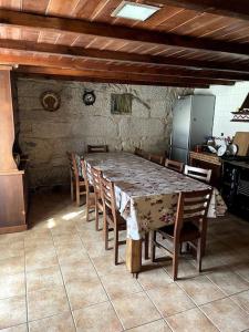 a dining room with a table and chairs in a kitchen at casa vella in Vilaboa