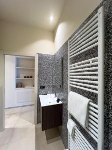 a bathroom with a sink and a mirror at La Villa Viale Verdi in Novara