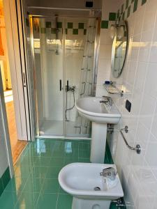 een badkamer met een wastafel en een douche bij Piazza Marconi Attico Duplex per 5 persone in Lido di Jesolo