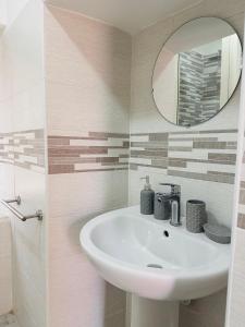 a bathroom with a sink and a mirror at Horus Home in Torre del Greco +19 photos