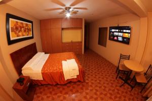 une chambre d'hôtel avec un lit et une table dans l'établissement Hostal The Princess, à Chaclacayo