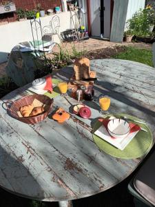 a table with food and drinks on top of it at Chambre "Savane Prestige" Esprit Safari Chez Fred in Gorron