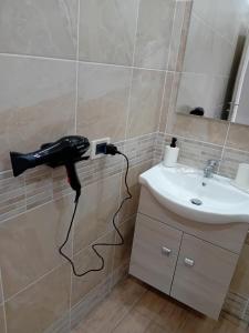 a black blow dryer plugged into a wall next to a sink at Vama House in Naples +26 photos