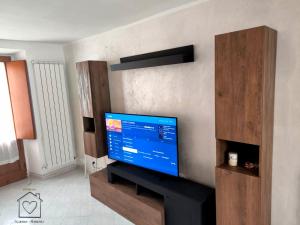 a living room with a flat screen tv on a wall at Room La Vicenna in Scanno