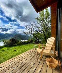 a wooden deck with a chair on a house at Kuro cottage- A frame in Kazbegi