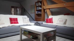 a living room with a couch and a table at La Fruitière d'Arith in Arith