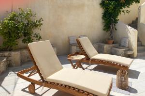 - une terrasse avec 2 chaises et une table dans l'établissement Malvazia Residence, à Kamilárion