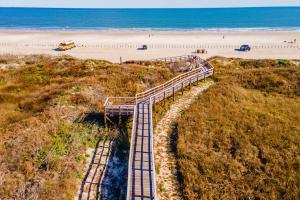 an aerial view of a boardwalk leading to a beach at Sand Vision - 3 bedroom condo at Sea Sands Condos in Port Aransas +34 photos