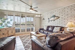 a living room with leather furniture and a fish on the wall at Sand Vision - 3 bedroom condo at Sea Sands Condos in Port Aransas