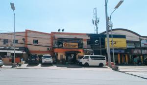 a group of cars parked in front of a building at RedDoorz at Elegance Guest House near NAIA T3 in Manila
