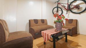 a room with a table with a bike hanging from a wall at RedDoorz at Elegance Guest House near NAIA T3 in Manila