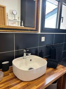 a bathroom with a white sink and a mirror at Chambres d'Hôtes En Aparté in Toulouse +22 photos