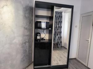 a mirror on a wall in a room at Bulevard Residence in Brăila