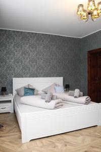A bed or beds in a room at Apartments Zámoček Staré časy