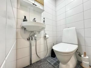 a bathroom with a toilet and a sink at Sleep and fly room - Homestay in Vantaa