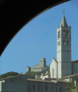 アッシジにあるLa Casa Di Famigliaの時計塔のある建物