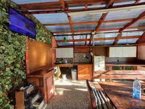 a living room with a table and a tv on a wall at Casa Marinela in Baile Felix