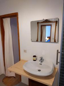 a bathroom with a white sink and a mirror at Mirabilia 1 in Chioggia