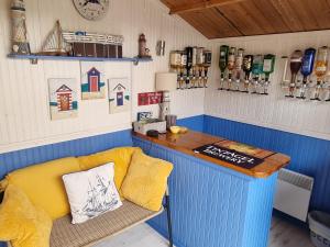 a bar with a couch and a table in a room at Dungarvon House B&B, Exclusive Bookings Only, Hot tub, Garden & Summerhouse, EV Point in Weston-super-Mare