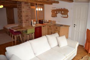 a living room with a white couch in a kitchen at Lovely view apartments in Sighişoara