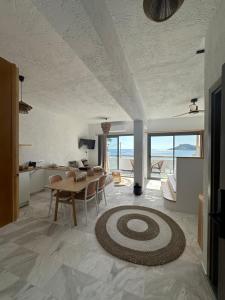 cocina y sala de estar con mesa y sillas en SPONGIA HOTEL AND SUITES en Myrties