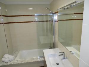 a bathroom with a tub and a sink and a shower at A casa da Abunana in Cangas de Morrazo +26 photos