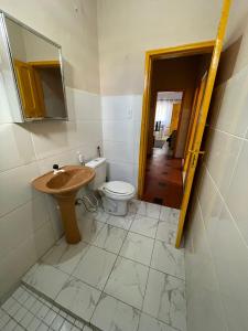 a bathroom with a sink and a toilet and a mirror at Casa Praia Grande in Praia Grande +11 photos