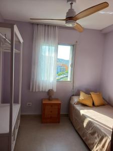 a bedroom with a bed and a window at Peñiscola Playa FRENTE AL MAR in Peniscola