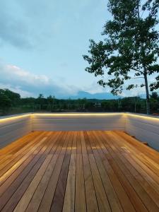 a wooden deck with a tree in the background at Kita Karuizawa Morino Takibi Dogs OK! in Tsumagoi