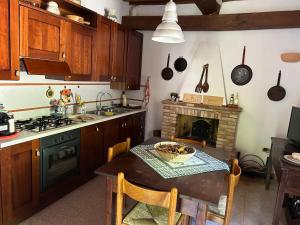 a kitchen with a table and a stove top oven at Casa vacanze San Rocco in San Venanzo