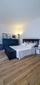 a bedroom with a large bed and a wooden floor at Appartamento I Cipressi in Castiglione del Lago