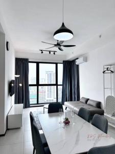a living room with a table and a couch at Hakuna Matata Apartment Urban Suites Jelutong in Jelutong