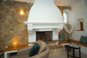 a living room with a stone fireplace and a couch at 06Q - Biot beautiful provencal villa with swimming pool in Biot