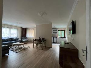 a living room with a couch and a table at Aygün Home Apart in Çaykara