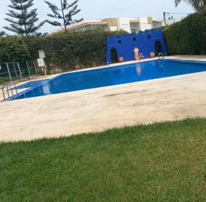 a large swimming pool in a yard next to a yard at Puerto Marina Dar Bouazza in Dar Bouazza