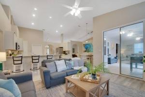 a living room with a couch and a table at Game room ,Saltwater ,pool Spa - Tropical Oasis! in Palm Coast
