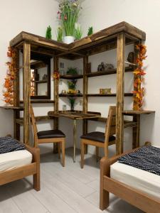 a room with two beds and a table and shelves at Leptir in Zagreb