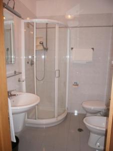 a bathroom with a shower and a sink and a toilet at Hotel Manzoni in Ponte San Giovanni