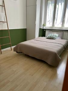 a bedroom with a bed with a pillow and a ladder at Claudia's Home in FieraCity&MiCo&SanSiro in Milan