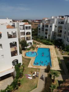 an aerial view of an apartment complex with a swimming pool at Assilah Marina Golf chez Ahmed in Asilah
