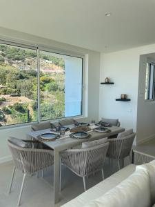 a dining room with a table and chairs and a large window at NEW ocean view private property centrally located, just 3 minutes to Marbella city center in Ojén