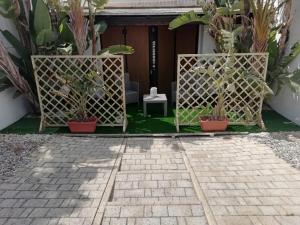 a patio with potted plants in front of a building at Sole&Mare in Monopoli
