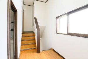 a staircase in a white room with a window at 青柳館 Aoyagi-Kan in Hakodate