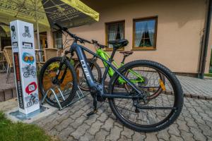 a bike is parked in front of a building at Hotel Elsyn Dvůr in Stachy